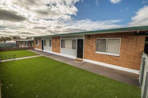 a house with a green lawn in front of it at Willow Court Unit 3 in Broken Hill