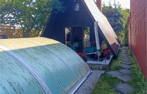 a small house with a large water tank in front of it at 2 Bedroom Lovely Home In Badersleben in Badersleben
