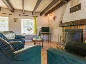 a living room with blue furniture and a fireplace at Gîte Saint-Lyphard, 4 pièces, 6 personnes - FR-1-306-1093 in Saint-Lyphard