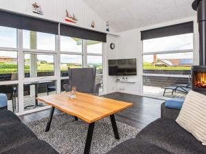 a living room with a table and a fireplace at 5 person holiday home in Hejls in Hejls