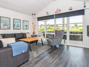 a living room with a couch and a table at 5 person holiday home in Hejls in Hejls