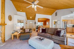 a living room with a couch and a ceiling fan at Bachelor Sunshine Retreat in Sunriver