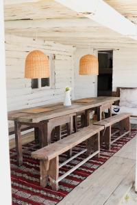 a wooden table with two benches in a room at Salty House Cabo Polonio in Cabo Polonio