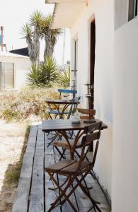 two chairs and a table on a patio at Salty House Cabo Polonio in Cabo Polonio +64 photos