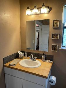 a bathroom with a sink and a mirror at Trails End Retreat in Bandera