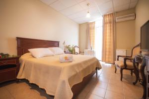 a bedroom with a bed with a laptop on it at Hotel del Sol in Tarija