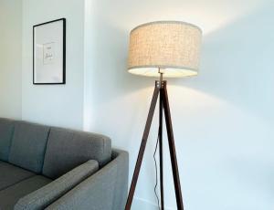 una lámpara de pie en una sala de estar junto a un sofá en Lovely 2 bedroom downtown suite with free parking, en Victoria