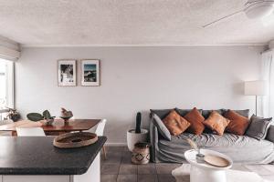 a living room with a couch and a table at Bay Properties Pacific Sun in Yamba