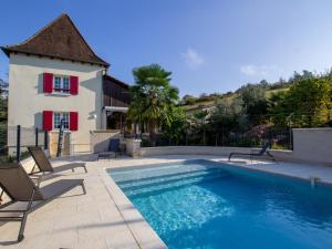 a swimming pool with chairs and a house at Maison de charme avec piscine privée, salle de sport proche de Bergerac et Périgueux - FR-1-616-132 in Villamblard