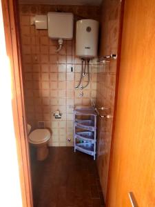 a small bathroom with a toilet and a sink at Apartments Sunset Jadranovo in Jadranovo +56 photos