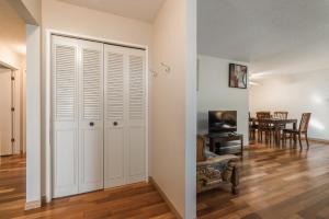 an empty living room with a closet and a table at H-Home by Deerfoot city in Calgary