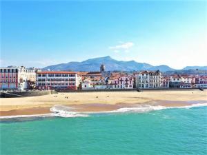 widok na plażę z budynkami i ocean w obiekcie Appartement moderne avec parking proche centre et plage - FR-1-4-638 w mieście Saint-Jean-de-Luz +5 zdjęć