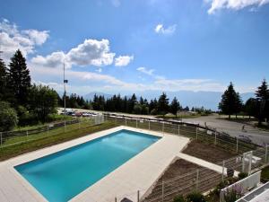 a swimming pool in a yard with a parking lot at Studio Chamrousse, 1 pièce, 4 personnes - FR-1-549-90 in Chamrousse