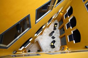 an overhead view of a yellow building with tables and chairs at Hotel San Rocco in Muggia