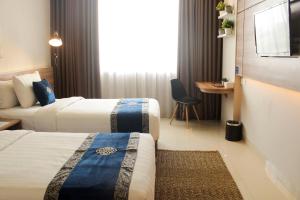 Vuode tai vuoteita majoituspaikassa Antero Hotel Jababeka