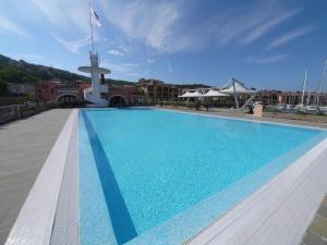 a large swimming pool on the roof of a building at Hotel San Rocco in Muggia