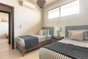 a bedroom with two beds and a window at Aqua in Playa del Carmen +59 photos