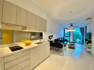 a kitchen with white cabinets and a dining room at Laguna cassia residences in Bang Tao Beach