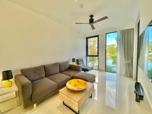a living room with a couch and a table at Laguna cassia residences in Bang Tao Beach