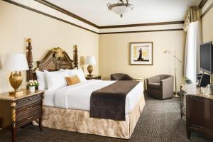 a hotel room with a bed and a television at Hotel Lucerne in New York +32 photos