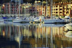 a group of boats are docked in a harbor at Hotel San Rocco in Muggia