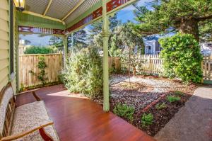 a porch with a pergola and a wooden fence at Eamont On Sackville in Port Fairy