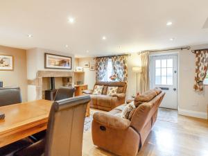 a living room with a couch and a table at Willow View in Stony Middleton