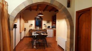 an archway in a kitchen with a table and chairs at Villa Evenos with private pool in Elafonisi