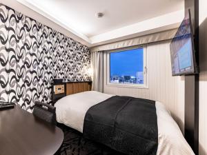 Postel nebo postele na pokoji v ubytování APA Hotel Ueno Ekiminami