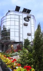 a building with a sign on the side of it at Garden Spa Boutique Hotel in Skopje