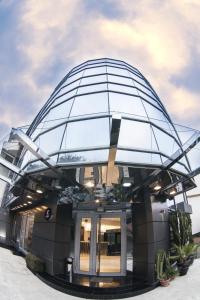 a circular building with a glass dome on top at Garden Spa Boutique Hotel in Skopje