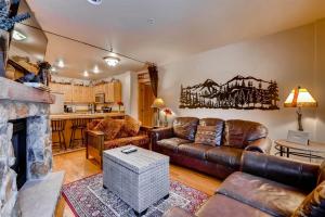 a living room with a couch and a fireplace at 2 Bedroom Colorado Vacation Rental In River Run Village With Pool And Hot Tub Access in Keystone
