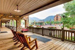 a deck with chairs and a view of the mountains at 2 Bedroom Colorado Vacation Rental In River Run Village With Pool And Hot Tub Access in Keystone