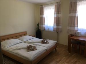 a bedroom with a bed with two towels on it at Lindenhof Ybbs in Ybbs an der Donau