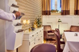 a person standing in a room with a table and chairs at Hotel Royal in Gothenburg