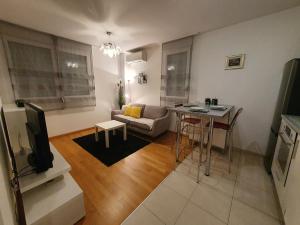 a living room with a couch and a table at Beata East Side apartment in Split