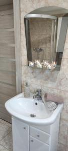 bagno con lavandino bianco e specchio di Chata u kolára a Malatiná