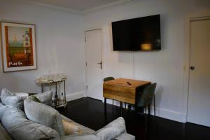 a living room with a couch and a table at The George @ The “G” in Melbourne