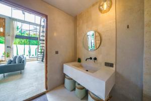 a bathroom with a sink and a mirror at Villa Upeksha - Huge 1-bedroom Villa with pool in Pererenan in Munggu +79 photos
