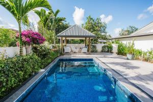a swimming pool in a backyard with a gazebo at Platinum Cawa Apartments in Nadi