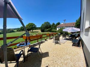 a patio with chairs and tables and a fence at EssenceCiel 