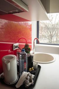 a kitchen counter with a coffee maker on a tray at Iassium Residence Iasi in Iaşi