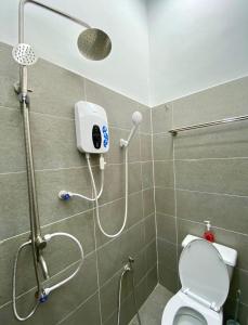 a shower stall with a toilet in a bathroom at Homestay Myya in Beris Tok Saboh