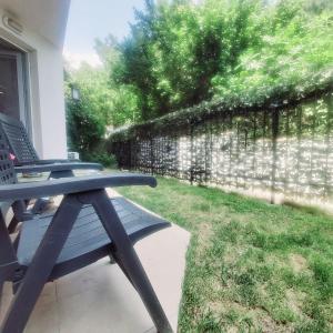 a picnic table sitting on a porch next to a stone wall at Saint Nicholas Varna Lovely 2 bedroom apartment with sunny garden in Varna City