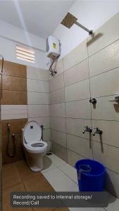 a bathroom with a toilet and a shower in a stall at COCHIN HOMES in Cochin +9 photos