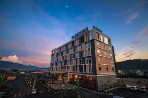 a hotel building with a sign on top of it at Petro Inn Takengon in Takengon