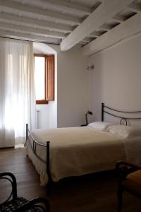 a bedroom with a bed in a room with a window at A due passi da Ponte Vecchio in Florence