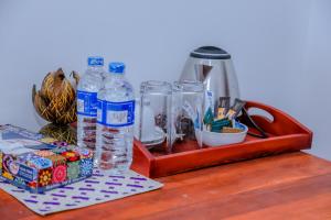 a wooden table with bottles of water and a box at Coral Beach Hotel in Mirissa