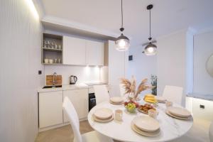 a kitchen and dining room with a white table and chairs at Luxury Villa Christian in Umag