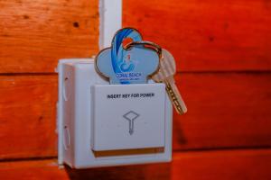 a pair of keys on top of a lightswitch at Coral Beach Hotel in Mirissa